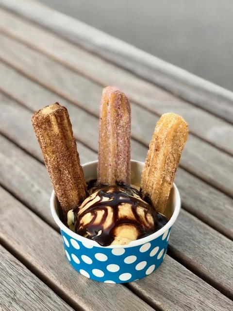 Ice cream combo cup with churros and chocolate syrup
